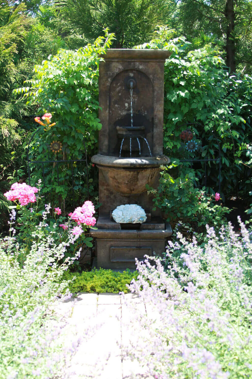 Flowers by stone fountain