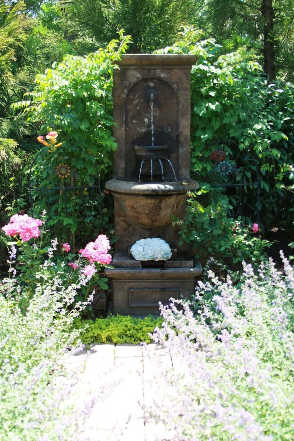 Flowers by stone fountain